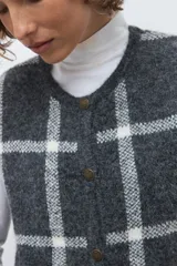 Chaleco de punto jacquard con diseño de cuadros, cuello redondo y cierre frontal con botones.