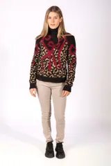 Sweater de cuello alto con diseño de estampado animal print combinado con detalles gráficos en color bordó. Presenta puños y ruedo acanalados en color negro.