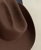 Sombrero texano marrón confeccionado artesanalmente en Uruguay con lana merino. Cuenta con cinta elástica interior para adaptarse a diferentes talles.