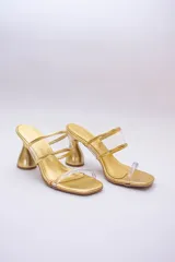 Sandalias plateadas con taco de forma geométrica y tiras transparentes.