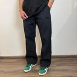 Pantalón de jean corte baggy, color negro, con diseño holgado y tiro medio.