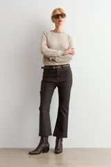 Pantalón de corte cropped y tiro alto, con acabado engomado en color chocolate. Presenta diseño de cinco bolsillos y cierre frontal con botón y cremallera.