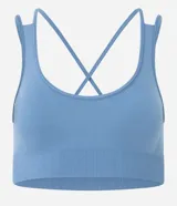 Top deportivo Get Over confeccionado en poliamida seamless, con escote redondo, breteles cruzados en la espalda y diseño sin costuras para mayor comodidad.