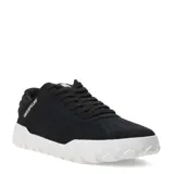 Zapatos Caterpillar modelo Hex, color negro, estilo casual de caña baja con cordones. La capellada es de gamuza y la suela es gruesa de goma blanca con textura de panal de abeja.