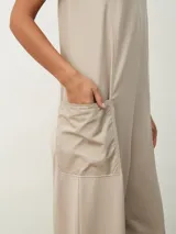 Monoprenda color beige claro, de corte holgado y diseño minimalista, con bolsillos laterales de parche.