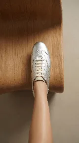 Zapato de cuero plateado con diseño minimalista, cordones al tono y suela plana flexible. Combina la comodidad de un champión con la estética de un zapato formal.