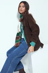 Jean de corte recto y silueta relajada, confeccionado en denim azul. Presenta una hilera de tachas metálicas decorativas a lo largo de los laterales de ambas piernas.