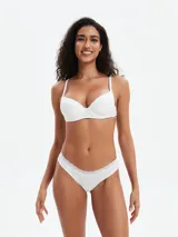 Bombacha de bikini blanca, corte clásico, con borde de encaje fino en la cintura.