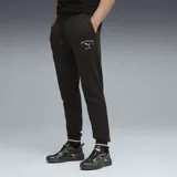 Pantalón de jogging Puma color negro, con cintura elástica ajustable con cordón, puños acanalados en los tobillos y logo de la marca estampado en la pierna.