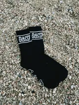 Pack de dos pares de medias negras con la palabra "Glassy" en blanco en la parte superior.