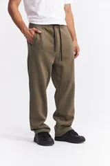 Pantalón de algodón de corte recto y estilo relajado, color beige. Cuenta con cintura elástica con cordón de ajuste, bolsillos laterales y logo de la marca estampado discretamente en el frente.