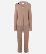 Pijama largo de dos piezas confeccionado en viscolycra color marrón. La blusa presenta escote en V con cuello tipo solapa, manga larga y detalles de piping en contraste. El pantalón cuenta con cintura elástica y diseño recto con terminaciones en piping.