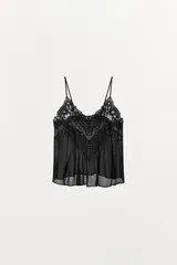 Top lencero de tirantes finos ajustables, confeccionado en tejido semitransparente con detalles de bordados y abalorios a tono en el escote.