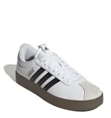 Championes Adidas VL Court 3.0 de estilo urbano, con capellada de cuero sintético blanco, icónicas tres tiras laterales en negro y puntera de gamuza en tono gris claro. Presenta una suela vulcanizada de color marrón oscuro y cierre mediante cordones.