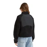 Campera de polar tipo sherpa color negro, con paneles frontales de tela técnica, cierre frontal completo y bolsillos con cierre. Presenta un bolsillo adicional en el pecho con cierre en contraste color verde lima.