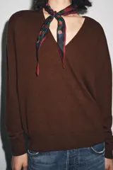 Jersey de punto confeccionado en 100% lana, con escote en pico y manga larga. Presenta acabados en rib en puños y bajo.