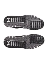 Championes de golf Under Armour, modelo Drive Medal SL, en color negro con detalles en gris y suela blanca. Presentan parte superior de microfibra, mediasuela con tecnología Charged Cushioning para amortiguación y suela exterior sin tacos para mayor flexibilidad y tracción.