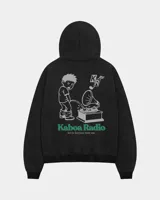 Canguro negro de algodón y poliéster con capucha y bolsillo tipo canguro. Presenta un estampado gráfico en la espalda con diseño estilo caricatura, letras verdes que dicen "Kaboa Radio" y la frase "Not for Everyone. Never was.".