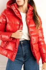 Campera puffer roja con capucha, calce al cuerpo y terminación engomada.
