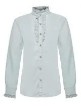 Blusa de manga larga confeccionada en Tencel color celeste claro. Presenta cuello alto con volados, cierre frontal con botones y detalles de volados en la pechera y en los puños.