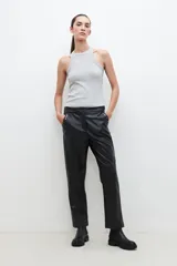 Pantalón de eco cuero negro, de corte recto, con tachas plateadas en los bolsillos delanteros.