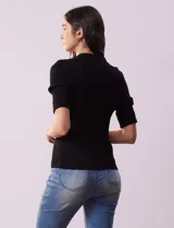 Buzo azul de tejido acanalado, con cuello solapa y escote en V en tejido calado.