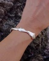 Brazalete rígido abierto de plata 925 con diseño orgánico irregular.