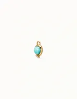 Dije de piercing dorado con forma circular y cristal celeste.