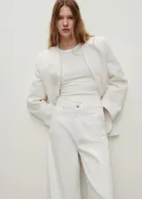 Pantalón de jean estilo wideleg, de tiro alto y corte largo, con diseño de cinco bolsillos, trabillas para cinturón y cierre frontal con cremallera y botón.