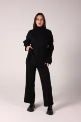 Conjunto de dos piezas compuesto por un sweater de cuello alto y pantalón de corte recto, ambos confeccionados en tejido de punto acanalado.