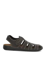 Sandalias de cuero color marrón oscuro con diseño tipo huarache o romano, costuras visibles en tono contrastante y cierre con tira ajustable de velcro en el empeine.