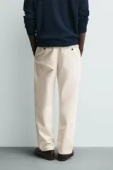 Pantalón de corte recto confeccionado en tejido compacto de algodón con estructura twill. Presenta cierre frontal con cremallera y botón, bolsillos laterales y bolsillos traseros de vivo con botón.