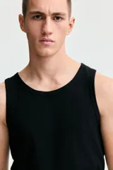 Musculosa H&M de corte ajustado, confeccionada en tejido de punto acanalado de mezcla de algodón. Presenta cuello redondo y bajo recto.