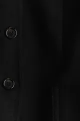 Blazer entallado negro en mezcla de lino y viscosa, con cuello redondo, hombreras finas, botones hasta la cintura y bolsillos delanteros de parche. Abertura en los puños y forro interno.