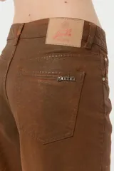 Jean de denim 100% algodón color marrón con coating engomado que le da un efecto cuero. Calce Mom con cintura alta y pierna recta.