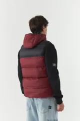 Chaleco puffer color borgoña y negro, con capucha y cuello alto.