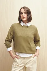 Sweater de punto fino color blanco, con cuello redondo, mangas largas y detalle de calado delicado en la parte superior del pecho, hombros y mangas.