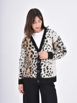 Cardigan de punto con diseño de animal print, cuello en V y cierre frontal con botones. Presenta puños y ruedo en tejido acanalado de color negro.