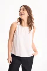 Blusa de lino color blanco, sin mangas y con cuello redondo.