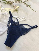 Pack de tres tangas de encaje con diseño de tiras laterales regulables. El conjunto incluye una pieza en color azul marino, una en color blanco y una en color champagne.