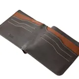 Billetera Rip Curl modelo Dosed Rfid Slim, color marrón, confeccionada en cuero con costuras a la vista en tono contrastante y logo de la marca grabado en el frente.