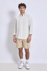 Camisa de corte regular con diseño de rayas verticales finas en tonos claros, cuello clásico y mangas largas con puños abotonados.