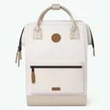 Mochila Cabaia modelo Adventurer Alger, color beige con detalles dorados. Cuenta con un bolsillo frontal con cierre, asas superiores y tirantes acolchados.