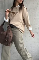 Sweater de punto color beige, de corte holgado y diseño básico con cuello redondo y mangas largas.