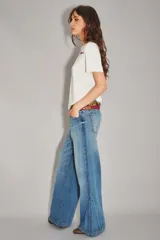Jean de corte wide leg en color azul claro con costuras laterales diagonales y ruedo desflecado.