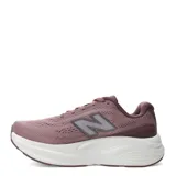 Championes New Balance Kaiha de mujer, color rosado con entresuela blanca y rosada clara, y suela marrón. Presenta el logotipo "N" característico en los laterales.