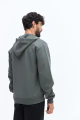 Campera de felpa azul marino con cierre frontal, capucha ajustable con cordones blancos y bolsillos canguro. Presenta un pequeño parche estampado en el pecho izquierdo.