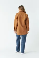 Sobrecamisa color marrón con cuello camisero, cierre frontal con botones, dos bolsillos con solapa en el pecho y corte holgado.