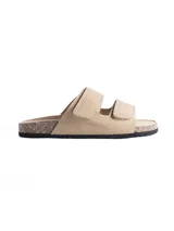Sandalia tipo birkenstock de color beige, con dos tiras ajustables con cierre de velcro, plantilla anatómica y suela de corcho con base de goma negra.