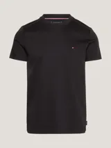 Remera negra de algodón elástico con corte slim fit, cuello redondo y logo de Tommy Hilfiger bordado en el pecho.